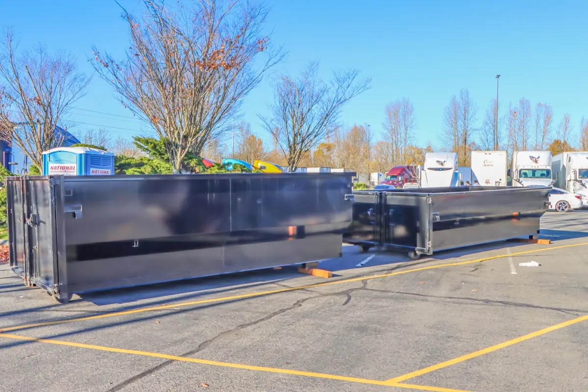 Professional dumpster rental service with roll-off container on residential driveway in Sheffield Lake